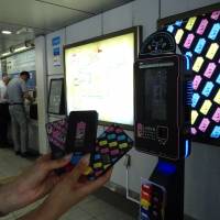 Portable chargers are shown Wednesday at Shinbashi Station with a dock station in the background. | KANTARO KOMIYA