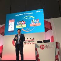 Alex Tsai, CEO of Osaka-based startup Beepnow, explains his blockchain-based business at the Japan Blockchain Conference in Tokyo on June 27. | KANTARO KOMIYA