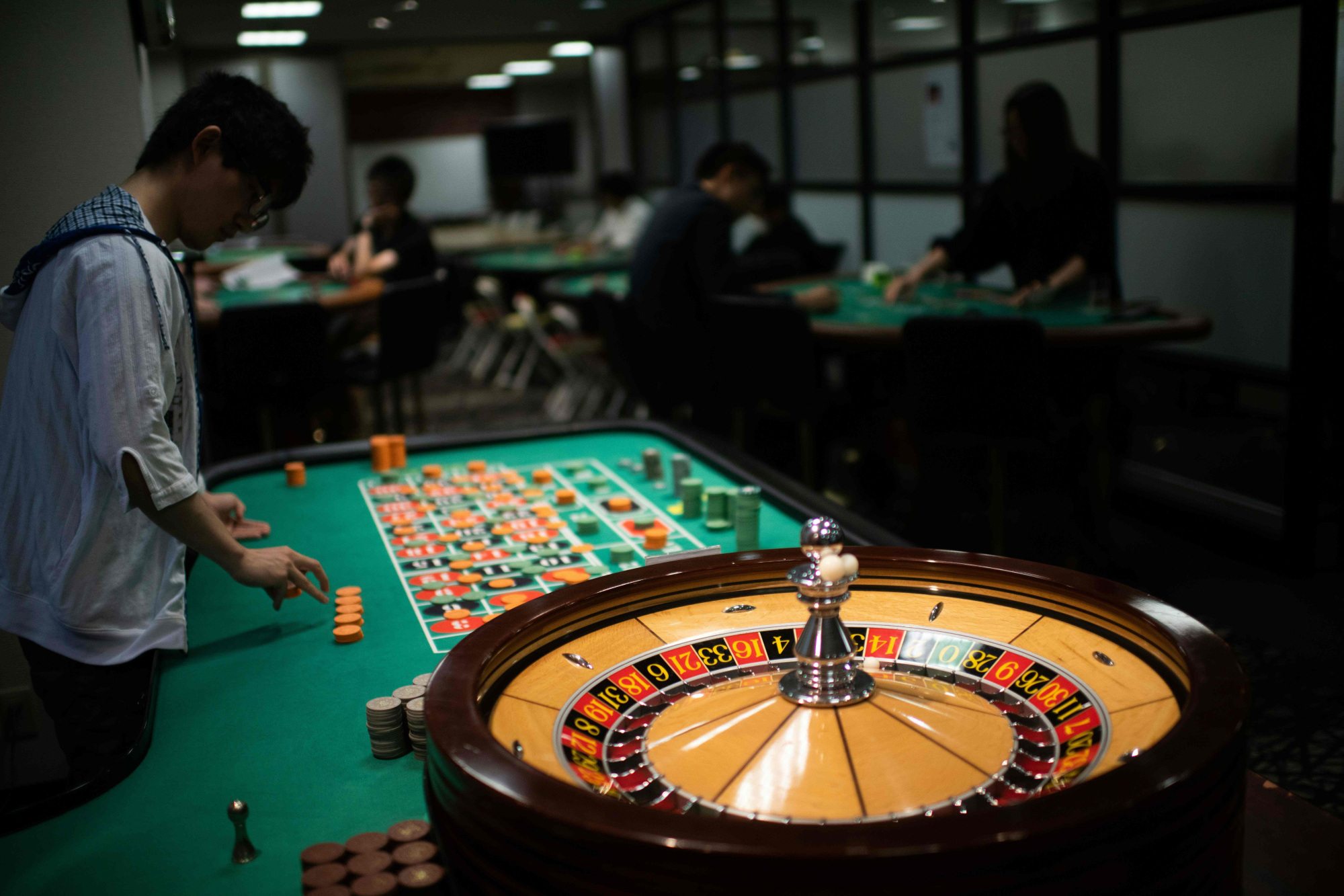 A student croupier practices dealing a game of roulette at the Japan Casino School in Tokyo on June 6. | AFP-JIJI