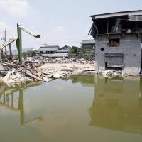 Some of the water that flooded the Mabicho district of Kurashiki, Okayama Prefecture, had not receded as of Sunday. | KYODO