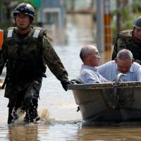 Self-Defense Force soldiers rescue people from a flooded area of Kurashiki, Okayama Prefecture, on Sunday. | REUTERS