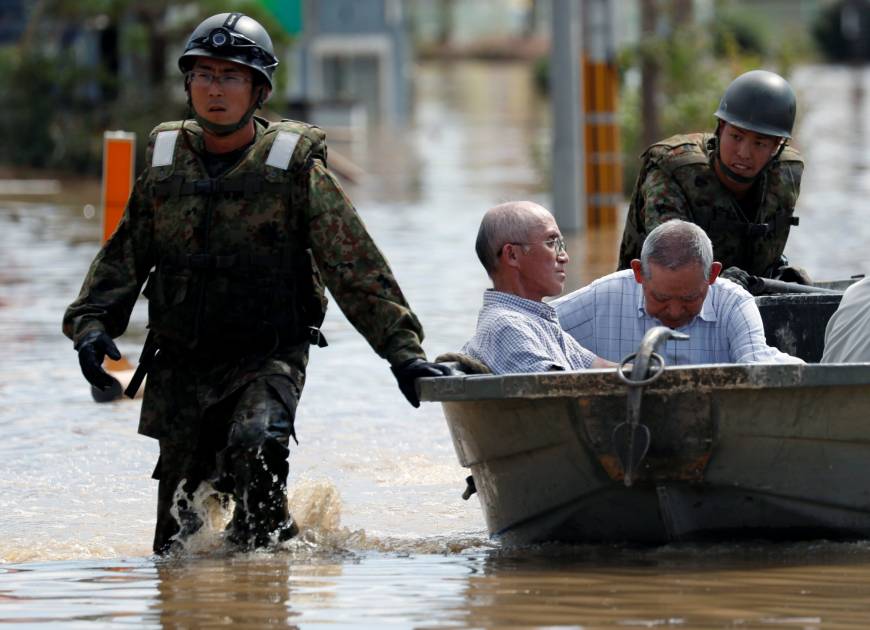 Self-Defense Force soldiers rescue people from a flooded area of Kurashiki, Okayama Prefecture, on Sunday.