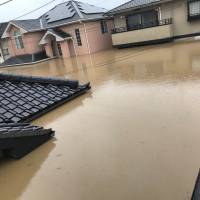 Homes are submerged in floodwater in Kurashiki, Okayama Prefecture, on Saturday, in this photo obtained from social media. | @RAATA_S660 / VIA REUTERS