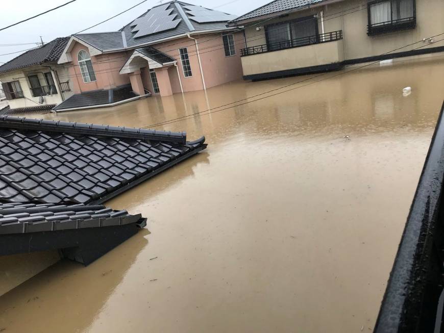 Homes are submerged in floodwater in Kurashiki, Okayama Prefecture, on Saturday, in this photo obtained from social media.