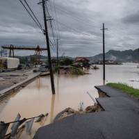 A washed out road is seen following heavy rains and flooding in Mihara, Hiroshima Prefecture, on Sunday. | AFP-JIJI