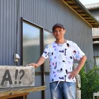 Hideki Kawakita, who runs real estate firm Loca LLC, is seen in front of his company\'s office in the city of Chiba late last month. | YOSHIAKI MIURA
