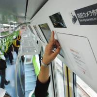 Newly installed security cameras on a Yamanote Line train are seen in Tokyo in May. | KYODO