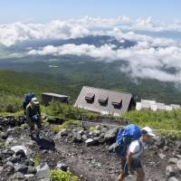 Climbers walk on Mount Fuji\'s Fujinomiya trail in Shizuoka Prefecture on Tuesday, as the climbing season begins in the prefecture for the 3,776-meter volcano. | KYODO