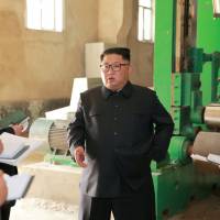 North Korean leader Kim Jong Un tours a factory in the city of Sinuiju in this undated photo released July 2. | REUTERS