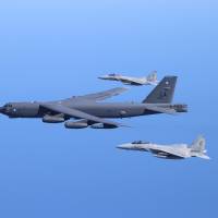 A U.S. Air Force B-52 bomber and two Air Self-Defense Force F-15 fighter jets conduct a bilateral training mission in the vicinity of Japan on Friday. | U.S. PACIFIC AIR FORCES
