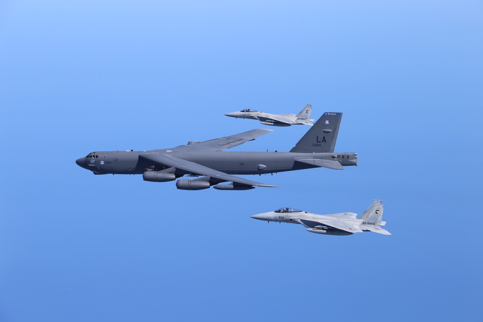 A U.S. Air Force B-52 bomber and two Air Self-Defense Force F-15 fighter jets conduct a bilateral training mission in the vicinity of Japan on Friday. | U.S. PACIFIC AIR FORCES