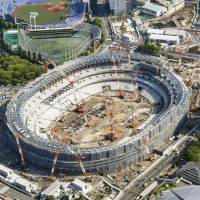 The main stadium for the 2020 Tokyo Games is seen under construction in April. Organizers for the games revealed ticket prices on Friday, including a &#165;300,000 price tag for the most expensive seats at the opening ceremony. | KYODO