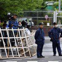 Police stand guard near the gate of the Tokyo Detention House in Adachi Ward where Aum Shinrikyo founder Shoko Asahara was executed on Friday. | SATOKO KAWASAKI