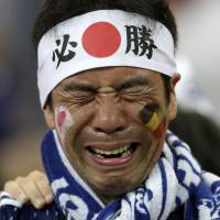 A Japan supporter is no longer able to hold back emotion, after the national team\'s loss to Belgium in a round of 16 match at the 2018 soccer World Cup in the Rostov Arena, in Rostov-on-Don, Russia, on Monday. | AP