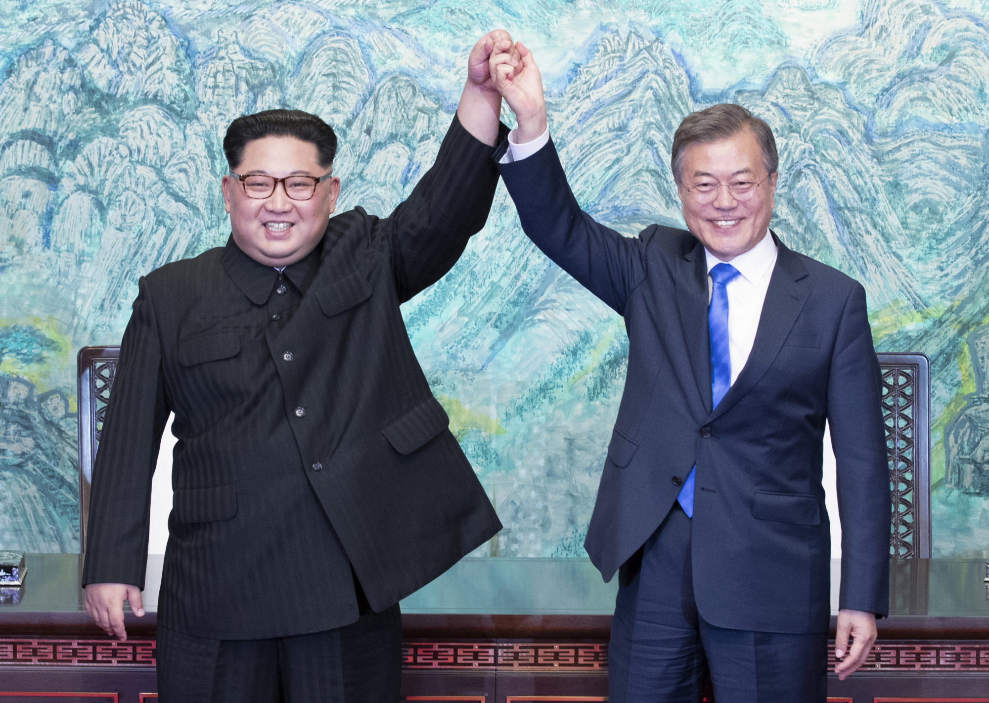 North Korean leader Kim Jong Un and South Korean President Moon Jae-in raise their hands during their April summit.