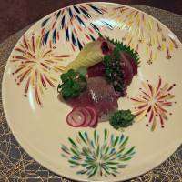 Sashimi served on a plate with a motif of fireworks. | J.J. O\'DONOGHUE