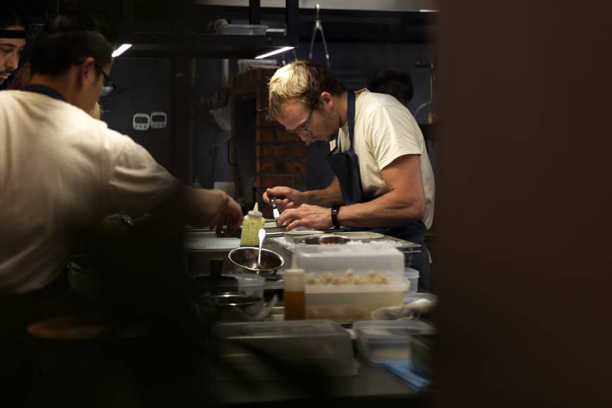 Noma alum: Thomas Frebel, head chef of Inua, prepping in the open kitchen. | JASON LOUCAS