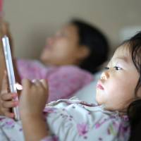 I screen, you screen: The number of families who are focused on their screens instead of each other is on the rise in Japan. | GETTY IMAGES