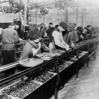 Workers piece together parts on the first moving assembly line in 1913 at a Ford Motor Co. plant. In the past, technological advances usually led to rapid rises in productivity. | PUBLIC DOMAIN