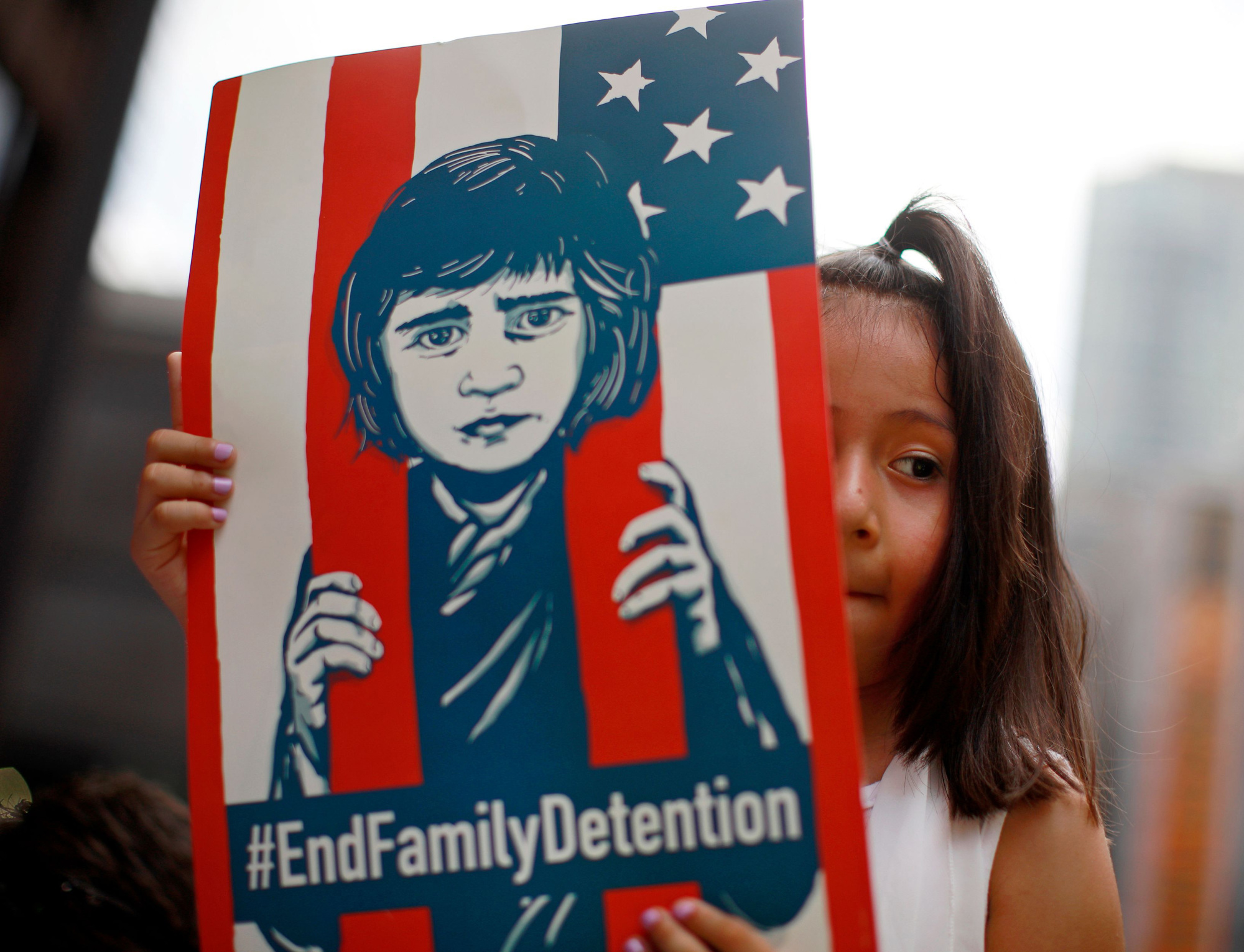 Pots and kettles: A girl takes part in a protest in Chicago last month against U.S.  immigration policies that led to the separation of thousands of migrant parents from their children. The situation in the U.S. now shouldn't distract activists from what is  happening in immigration detention centers in Japan, for example. | AFP-JIJI