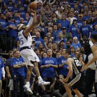 Vince Carter, seen in an April 2014 file photo knocking down a game-winning 3-pointer for the Mavericks against the Spurs, is set to play in his 21st NBA season. | AP