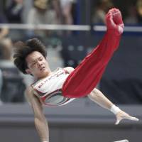 Yusuke Tanaka performs on the parallel bars on Sunday at the national apparatus championships in Takasaki, Gunma Prefecture. | KYODO