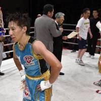 Nao Ikeyama reacts after losing to Mika Iwakawa (right) in their WBO atomweight title match on Sunday in Kyoto. | KYODO