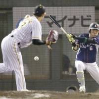 Pacific League shortstop Sosuke Genda hits a run-scoring double in the fifth inning against the Central League in Game 2 of the NPB All-Sar Series on Saturday in Kumamoto. The PL won 5-1. | KYODO