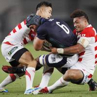 Japan\'s Amanaki Lelei Mafi (right) is seen in action against Scotland in  a June 2016 test match. He also plays for the Melbourne Rebels, a Super Rugby club. | KYODO