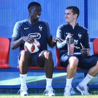 France\'s Paul Pogba (left) and Antoine Griezmann sit on the bench during a training session in Istra, Russia, on Friday. France will play Croatia in the World Cup final on Sunday in Moscow. | AFP-JIJI
