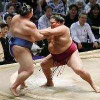 Mitakeumi forces Shodai out of the raised ring on Friday at the Nagoya Grand Sumo Tournament. | KYODO