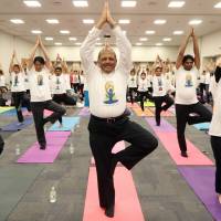 Indian Ambassador Sujan R. Chinoy (center) poses with Hakubun Shimomura (left), chairman of the Parliamentary League for the Promotion of Yoga, and Upper House lawmaker Michiko Ueno at a yoga session to celebrate International Yoga Day 2018 on June 19 at the Indian Embassy. | COURTESY OF THE INDIAN EMBASSY