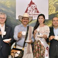 Colombian Coffee icon &#34;Juan Valdez&#34; poses for a photo with (from left) Colombian Ambassador Gabriel Duque, 2018 Miss International Queen of Coffee Japan Representaive Kanako Hirayama and Colombian Coffee Growers Federation Tokyo Director Santiago Pardo during an event to promote Colombian coffee at the embassy on July 11. | YOSHIAKI MIURA