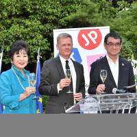 French Ambassador Laurent Pic (center) poses for a photo with former Vice President of the Upper House Akiko Santo (left) and Foreign Minister Kono Taro during a reception to celebrate France\'s national day at the ambassador\'s residence in Tokyo on July 15. | YOSHIAKI MIURA