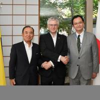 Colombian Ambassador Gabriel Douque (center) poses for a photo with Colombia-Japan Friendship Association President Tatsumaro Terasawa (left) and Latin American and Caribbean Affairs Bureau Director-General Takahiro Nakamae during a reception to celebrate Colombia\'s independence day at the embassy on July 20. | YOSHIAKI MIURA