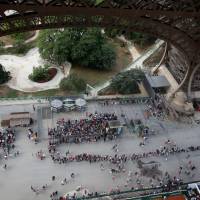 Visitors line up to visit the Eiffel tower in Paris June 2. | REUTERS