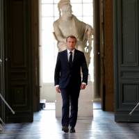 French President Emmanuel Macron walks through the Galerie des Bustes (Busts Gallery) to access the Versailles Palace\'s hemicycle to address both the upper and lower houses of the French parliament (National Assembly and Senate) at a special session in Versailles near Paris July 9. | REUTERS