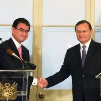 Foreign Minister Taro Kono (left) and his Peruvian counterpart Nestor Popolizio shake hands after a news conference in Lima, Peru, on Tuesday. | REUTERS