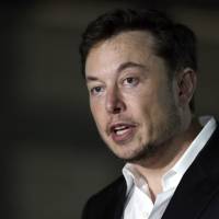 Tesla CEO Elon Musk speaks at a news conference in Chicago June 14. Tesla is forming a special committee to evaluate Musk\'s plan to take the company private. | KIICHIRO SATO / VIA AP