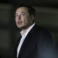 Tesla CEO Elon Musk speaks at a news conference on June 14. | AP