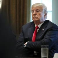 U.S. President Donald Trump listens during a meeting in the Cabinet Room of the White House in Washington on Thursday. | BLOOMBERG