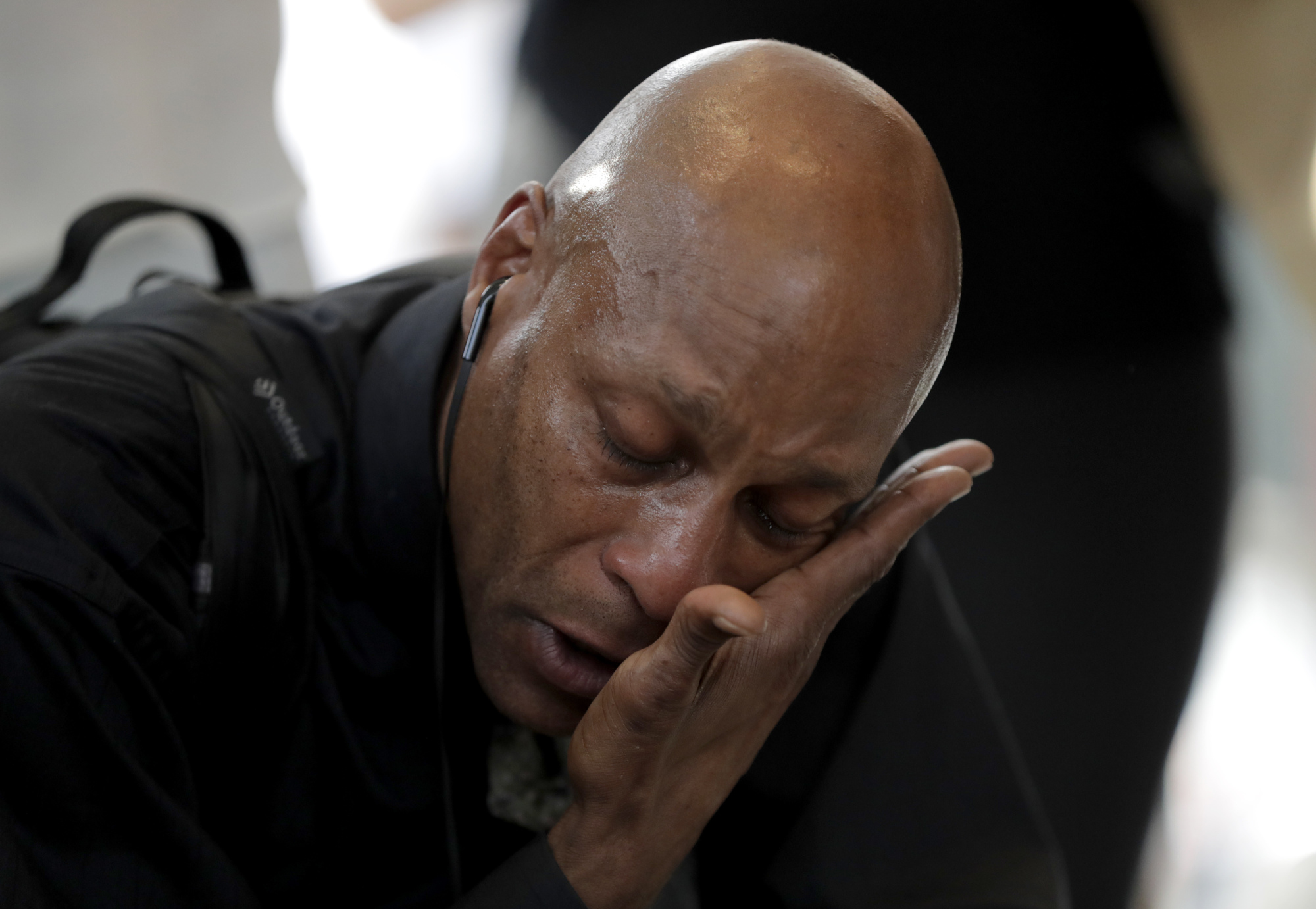 Gary Vincent, a singer from New York, cries while stopping to pay respects at a makeshift memorial at the nameplate for singer Aretha Franklin outside the Apollo Theater in the Harlem section of New York City Thursday. Franklin died Thursday in her home in Detroit at age 76 from pancreatic cancer. | AP