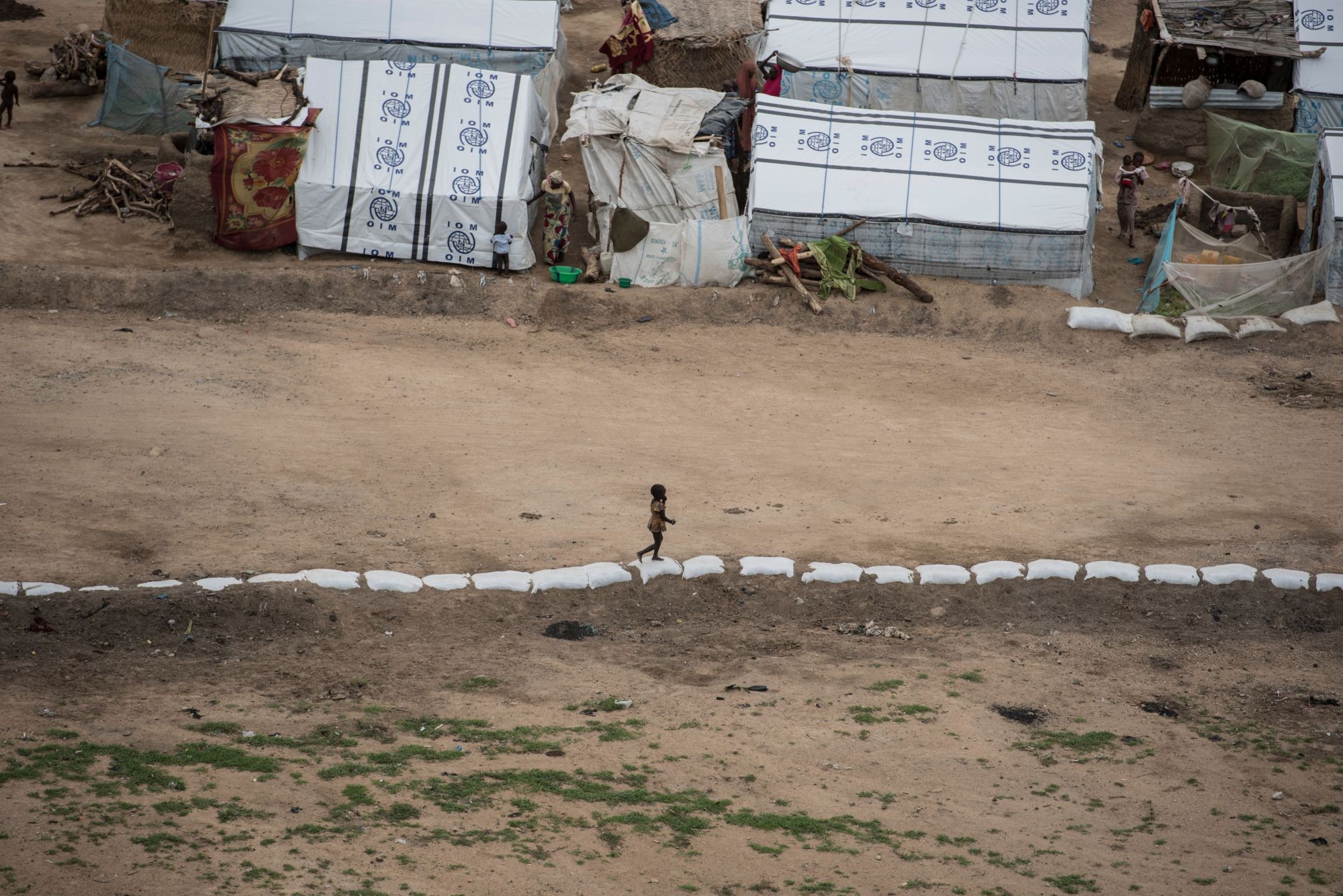 A child plays on her own on the outskirts of one of the IDP (Internally Displaced People) camps in Pulka, Nigeria, on Aug. 1. | STEFAN HEUNIS / VIA AFP-JIJI
