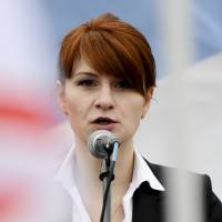 Maria Butina, leader of a pro-gun organization in Russia, speaks to a crowd during a 2013 rally in support of legalizing the possession of handguns in Moscow. Moscow claims the Russian woman arrested in the United States on charges of acting as an unregistered foreign agent for Russia is being mistreated in jail. | AP