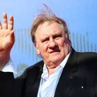 Gerard Depardieu waves as he arrives during a red carpet event for the movie \"Novecento &#8212; Atto Primo\" at the 74th Venice Film Festival in Venice, Italy, last September. | ALESSANDRO BIANCHI / VIA REUTERS