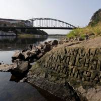One of the \'hunger stones\' revealed by the low level of water in the Elbe River is seen in Decin, Czech Republic, Wednesday. | DAVID W CERNY / VIA REUTERS