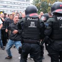 Riot police confront right-wing protesters Monday in Chemnitz, eastern Germany, following the death of a 35-year-old German national who died in a hospital after a \"dispute between several people of different nationalities,\", according to the police. The far-right street movement PEGIDA called for a second day of protests in Chemnitz after the alleged fatal stabbing of a German man by a foreigner. | SEBASTIAN WILLNOW / DPA / VIA AFP-JIJI