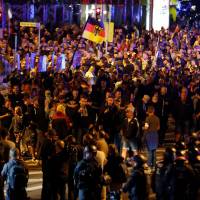 Right-wing demonstrators stage a rally on Monday in Chemnitz, eastern Germany, following the a death of a 35-year-old German national who died in hospital after a \"dispute between several people of different nationalities,\" according to the police. | ODD ANDERSEN / VIA AFP-JIJI