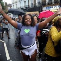 Revelers take part in the Notting Hill Carnival in London Sunday. | KEVIN COOMBS/ VIA REUTERS