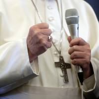 Pope Francis speaks with the media onboard a plane during his flight back from a trip to Dublin Sunday. | GREGORIO BORGIA / POOL / VIA REUTERS